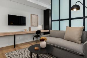 a living room with a couch and a table at The Carrington Aparthotel by Totalstay in Cape Town