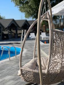 a wickericker swing chair sitting next to a pool at Holiday stay Nika in Busk