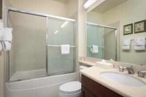 a bathroom with a shower and a toilet and a sink at Fairway Villas Waikoloa by OUTRIGGER in Waikoloa