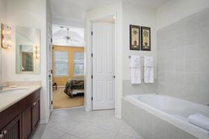 a bathroom with a tub and a sink and a bath tub at Fairway Villas Waikoloa by OUTRIGGER in Waikoloa