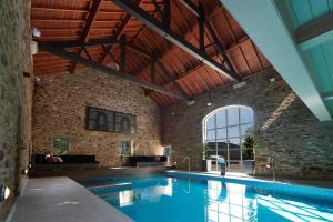 an indoor swimming pool with a brick wall at The Devonshire Arms Hotel & Spa - Skipton in Bolton Abbey