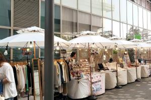 a market with umbrellas in front of a building at Hongdae Stn 3min 3R 2F #Core Stay 201 in Seoul