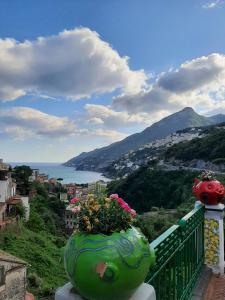 a vase filled with flowers sitting on a balcony at Casa Ricordi in Vietri sul Mare