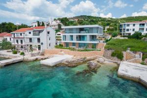 an aerial view of a house and a pool of water at D HOUSE in Stara Novalja