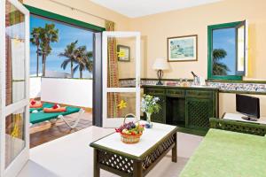 a living room with a view of the ocean at Puerto Caleta in Caleta De Fuste