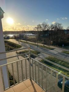 a view of a road from a balcony with a fence at Apartament Albatros in Darłowo