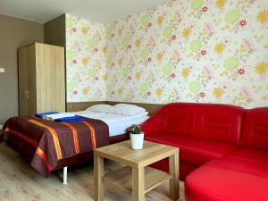 a living room with a couch and a bed at Arenia Łeba -Filia Kompleksu ARENA SŁOŃCA in Łeba +77 photos