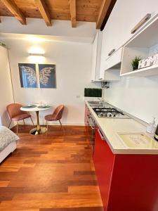 a kitchen with a counter top and a table at Apartment Bergamo Center in Bergamo