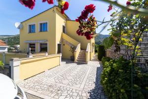 a villa with a pathway in front of a house at Apartments Zora in Senj