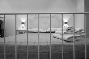 a bed with a metal bed frame and two lamps at Guest house San Lorenz in Rome