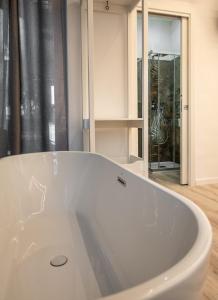 a white bath tub in a bathroom with a window at Guest house San Lorenz in Rome