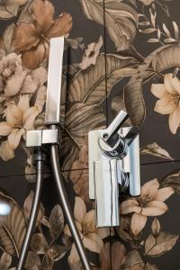 a charger on a wall with a floral wallpaper at Guest house San Lorenz in Rome