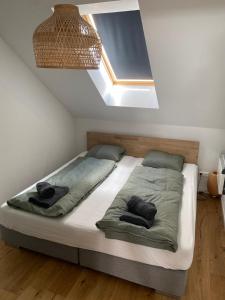 a bedroom with a bed with two pillows on it at Lendhafen in Klagenfurt