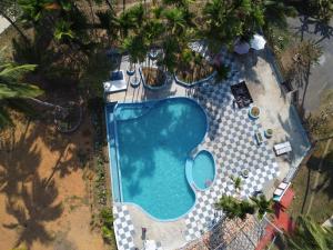 an overhead view of a swimming pool with palm trees at Adhvasaha Beach Spa Resort in Port Blair