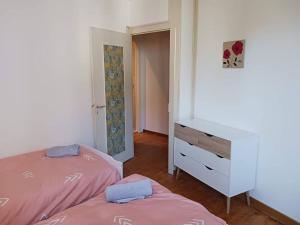 a bedroom with two twin beds and a dresser at Jonzac Centre Ville - Private Home near Chateau in Jonzac