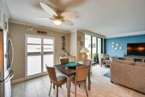 a kitchen and living room with a table and chairs at Coastal Marco Island Condo with Club Amenities! in Marco Island