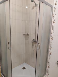 a shower with a glass door in a bathroom at Villa Rossa in Ravda