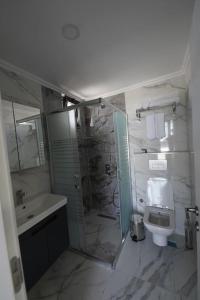 a bathroom with a shower and a toilet and a sink at Royal Homes 504 in Antalya