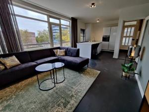 a living room with a couch and a table at Eindhoven City Apartments A 6P in Eindhoven