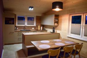 a kitchen with a wooden table and chairs in it at Rezort Zvernica Vlachy in Vlachy