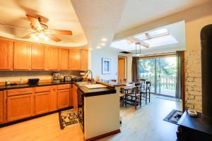 a kitchen with a ceiling fan and a dining room at The Fusion Retreat on 4 Acres Hike On-Site! in White Salmon