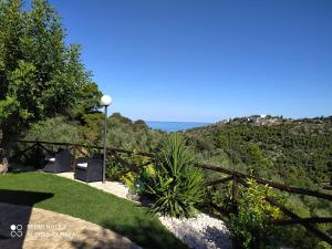 a garden with a view of the ocean and mountains at B&B Volver in Peschici
