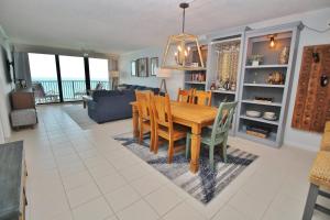 a dining room and living room with a table and chairs at Daytona Ashley Penthouse 4 in Daytona Beach Shores