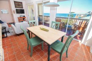 a dining room with a table and chairs and the ocean at Ocean Club at Turtle Mound 207 in New Smyrna Beach