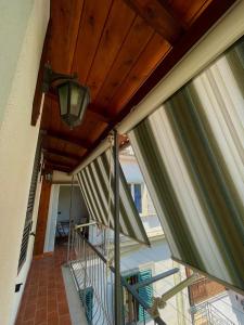 a balcony with awning and a ceiling with a light at Casa vacanze Casa Elena in San Giorgio a Cremano