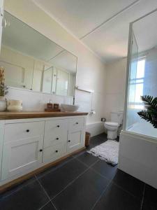a bathroom with a sink and a toilet at The Grayce Place. in Warrnambool