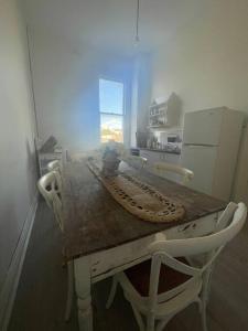 a kitchen with a table and chairs and a table and a window at The Grayce Place. in Warrnambool