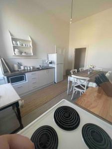 a kitchen with a white stove top oven in a room at The Grayce Place. in Warrnambool
