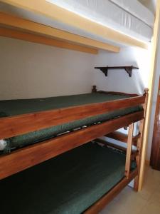 a wooden bunk bed in a room at La Mansarde – Apt. 4 personnes in Saint-Lary-Soulan