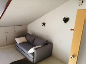 a living room with a couch and a star on the wall at La Mansarde – Apt. 4 personnes in Saint-Lary-Soulan