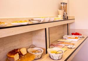 a counter with baskets of bread and other foods at Europa Hotel Brasília by Bsb Inn in Taguatinga