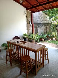 a wooden table and chairs in a room at Tranquil at Airport Reach in Gonawala