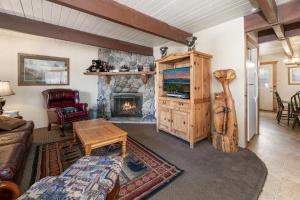 a living room with a fireplace and a couch at Bear Trap Cabin - Nice cabin in a quiet area with hot tub! in Big Bear City