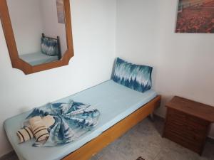 a bed in a room with a mirror at Dafni's Home 50 meters from the beach in Yerakiní