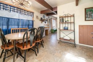 a dining room with a table and chairs at Bear Trap Cabin - Nice cabin in a quiet area with hot tub! in Big Bear City +14 photos