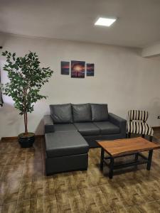 a living room with a couch and a table at Alojamiento El Cóndor in Esquel