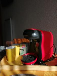 a coffee maker sitting on a table with a cup at La Mansarde – Apt. 4 personnes in Saint-Lary-Soulan