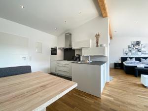 a kitchen and living room with a table and a couch at Staufenresidenz in Oberstaufen