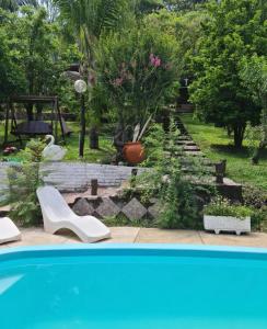 a backyard with a garden with a swimming pool at Las Watanas in Reyes