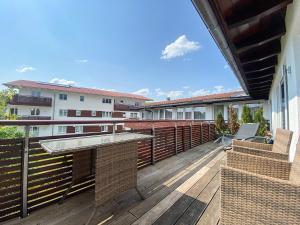 an outdoor deck with a table and chairs on a balcony at Staufenresidenz in Oberstaufen