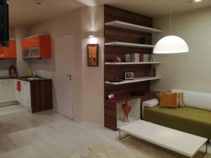 a living room with a couch and a kitchen at Top luxury apartment, great location in Sofia