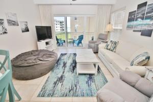 a living room with a couch and a table at Ocean Club North C208 in New Smyrna Beach