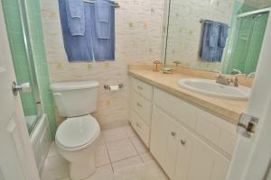 a bathroom with a toilet and a sink at Ocean Club North C208 in New Smyrna Beach +31 photos