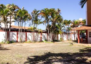 a group of palm trees in front of a building at Europa Hotel Brasília by Bsb Inn in Taguatinga