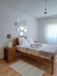 a bedroom with a bed and a mirror on the wall at Camarção Violante in Foz do Arelho
