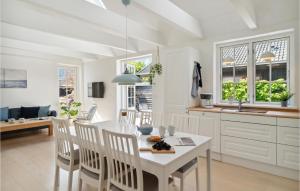 a kitchen and dining room with a white table and chairs at 3 Bedroom Gorgeous Home In Gilleleje in Gilleleje
